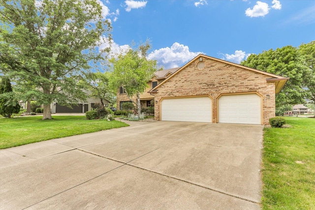 4008 Pinecrest Dr, Champaign, IL 61822 - view of front of house with brick siding, driveway, a front yard, and a garage