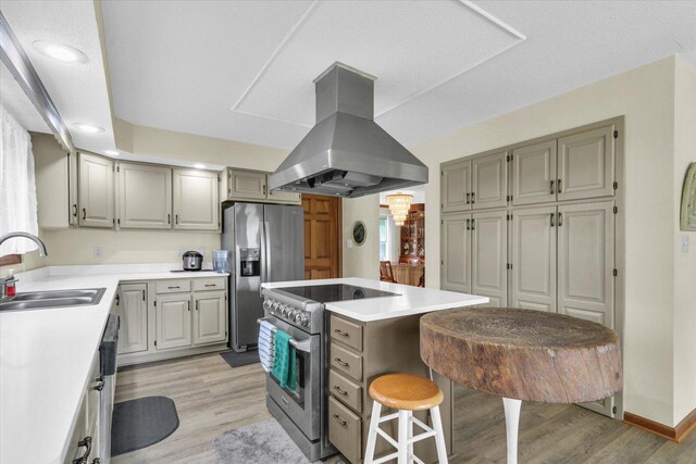 4008 Pinecrest Dr, Champaign, IL 61822 - kitchen featuring island range hood, stainless steel appliances, light wood-style flooring, gray cabinetry, and a kitchen bar