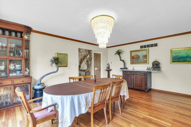 4008 Pinecrest Dr, Champaign, IL 61822 - dining area with a chandelier, light wood-type flooring, ornamental molding, and baseboards