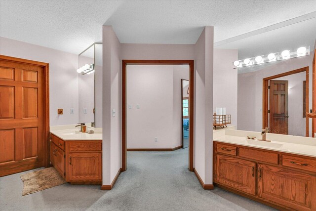 4008 Pinecrest Dr, Champaign, IL 61822 - full bathroom with two vanities, carpet floors, baseboards, and a textured ceiling