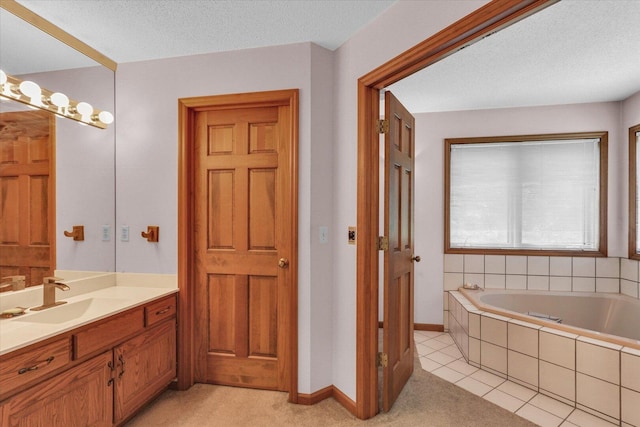 4008 Pinecrest Dr, Champaign, IL 61822 - bathroom featuring vanity, a garden tub, a textured ceiling, baseboards, and tile patterned flooring