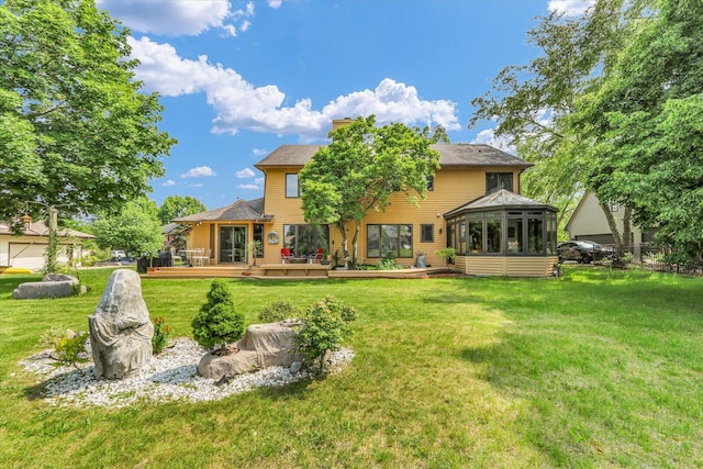 4008 Pinecrest Dr, Champaign, IL 61822 - back of house with a sunroom, a deck, a lawn, and a chimney