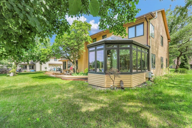 4008 Pinecrest Dr, Champaign, IL 61822 - rear view of house featuring a sunroom and a yard
