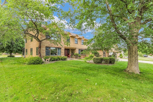 4008 Pinecrest Dr, Champaign, IL 61822 - traditional-style house featuring a front yard and brick siding
