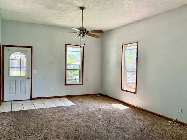 109 S Willow St, Toluca, IL 61369 - foyer with light colored carpet, a textured ceiling, a ceiling fan, and baseboards