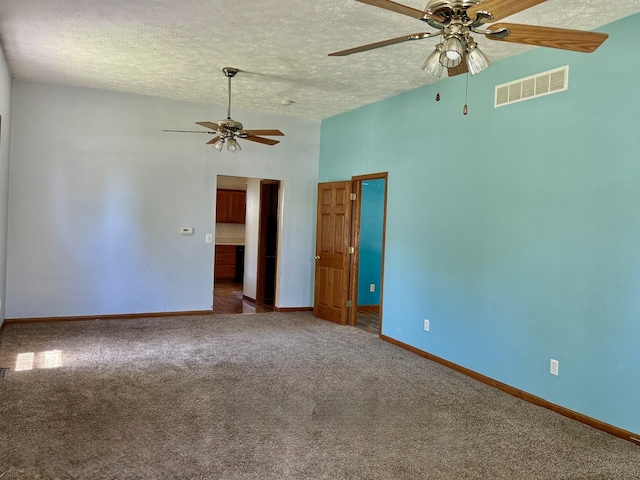 109 S Willow St, Toluca, IL 61369 - empty room featuring a ceiling fan, a textured ceiling, carpet floors, baseboards, and lofted ceiling