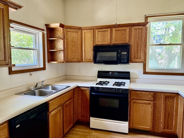 109 S Willow St, Toluca, IL 61369 - kitchen featuring black appliances, a sink, brown cabinetry, and light countertops