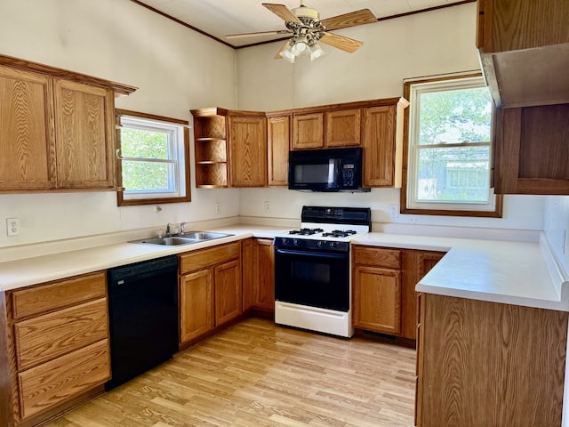 109 S Willow St, Toluca, IL 61369 - kitchen with black appliances, a sink, light wood-style floors, open shelves, and brown cabinetry