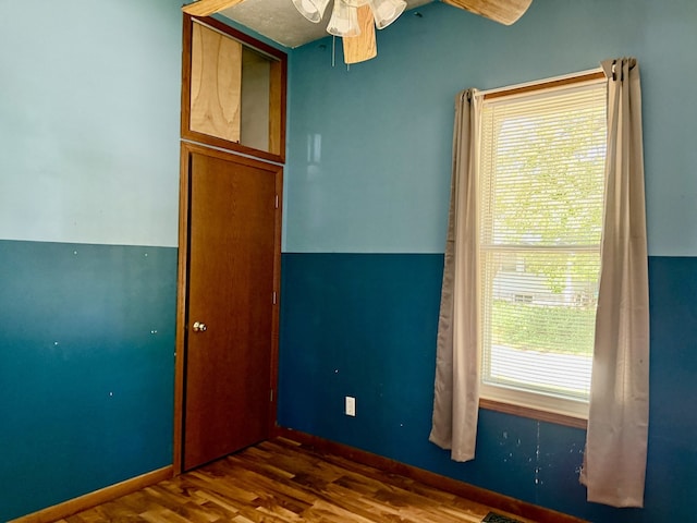 109 S Willow St, Toluca, IL 61369 - unfurnished bedroom with wood finished floors, baseboards, and ceiling fan