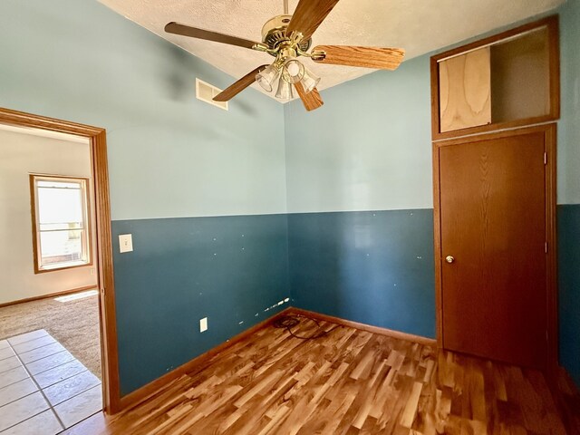 109 S Willow St, Toluca, IL 61369 - empty room featuring a ceiling fan, wood finished floors, baseboards, and a textured ceiling