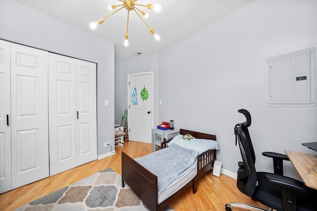 1637 W Columbia Ave Unit 3W, Chicago, IL 60626 - bedroom with electric panel, a chandelier, wood finished floors, a desk, and a closet