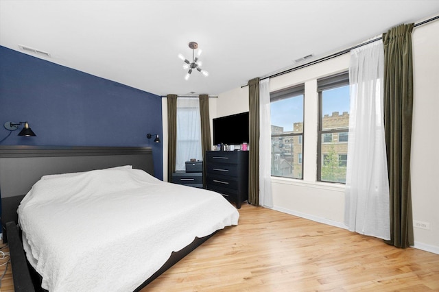 1637 W Columbia Ave Unit 3W, Chicago, IL 60626 - bedroom with light wood finished floors, baseboards, and a chandelier