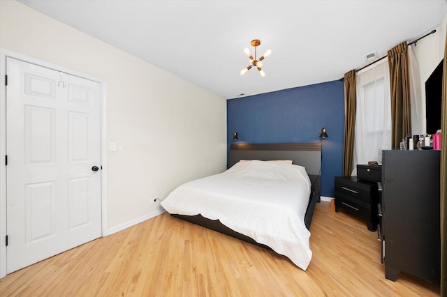 1637 W Columbia Ave Unit 3W, Chicago, IL 60626 - bedroom with light wood finished floors, a chandelier, and baseboards