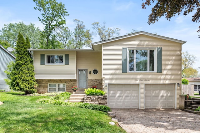 627 Raupp Blvd, Buffalo Grove, IL 60089 - split foyer home featuring a garage, a front yard, and concrete driveway