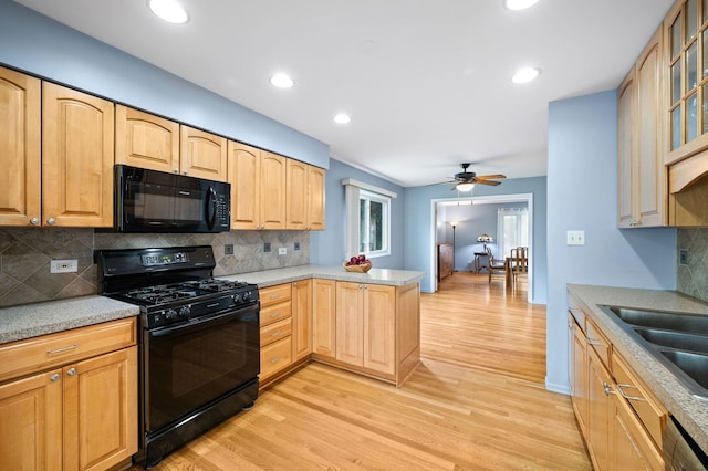 627 Raupp Blvd, Buffalo Grove, IL 60089 - kitchen with black appliances, light wood-style flooring, a peninsula, decorative backsplash, and recessed lighting
