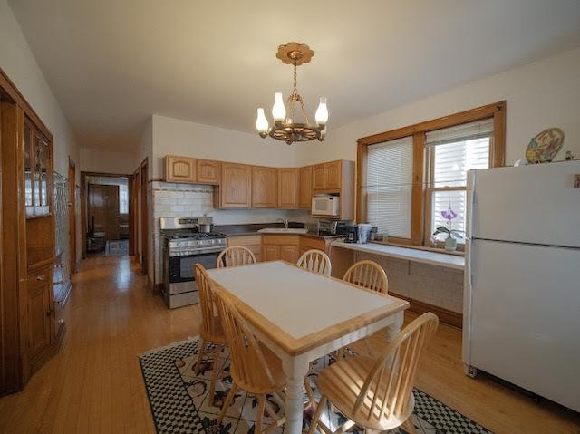 4912 S Komensky Ave, Chicago, IL 60632 - kitchen featuring white appliances, a chandelier, a sink, light wood-type flooring, and light brown cabinetry