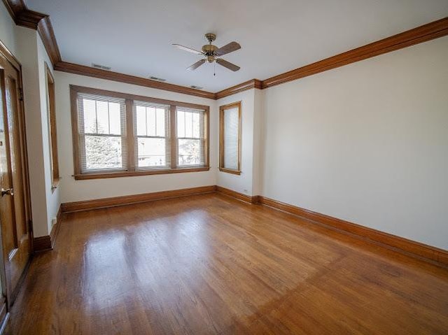 4912 S Komensky Ave, Chicago, IL 60632 - unfurnished room featuring ornamental molding, wood finished floors, ceiling fan, and baseboards