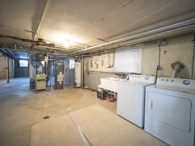 4912 S Komensky Ave, Chicago, IL 60632 - below grade area with water heater, washer and clothes dryer, and a sink