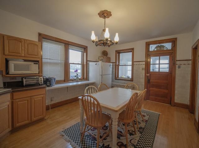 4912 S Komensky Ave, Chicago, IL 60632 - dining space featuring a chandelier, light wood-type flooring, wainscoting, and baseboards