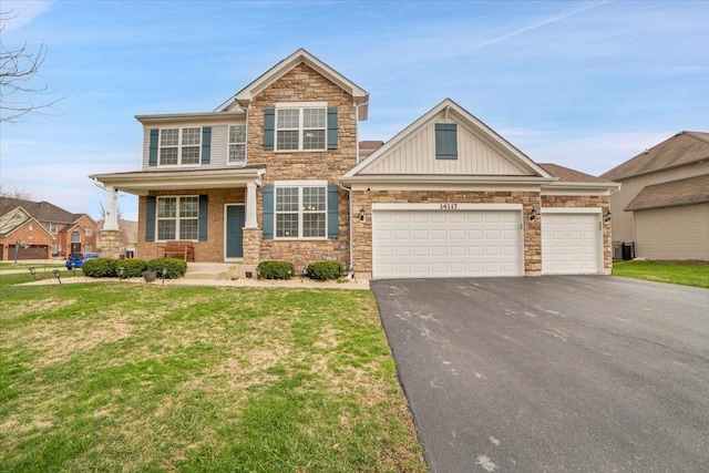 14117 Meadow Ln, Plainfield, IL 60544 - view of front facade with asphalt driveway, stone siding, an attached garage, board and batten siding, and a front lawn