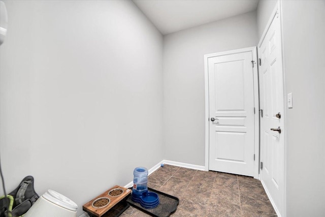 14117 Meadow Ln, Plainfield, IL 60544 - laundry room with baseboards and dark stone finish flooring