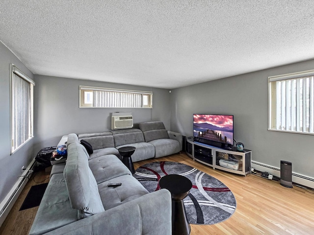2024 W 111th St Unit 3N, Chicago, IL 60643 - living area with wood finished floors, a textured ceiling, a wall unit AC, and baseboards