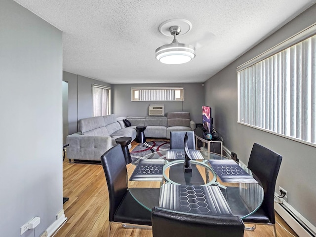 2024 W 111th St Unit 3N, Chicago, IL 60643 - dining area with a baseboard radiator, a textured ceiling, and wood finished floors