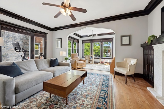 1621 W Rascher Ave Unit 2, Chicago, IL 60640 - living area with arched walkways, crown molding, light wood finished floors, ceiling fan, and a fireplace