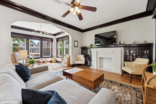 1621 W Rascher Ave Unit 2, Chicago, IL 60640 - living room with wood finished floors, crown molding, a fireplace, ceiling fan, and arched walkways
