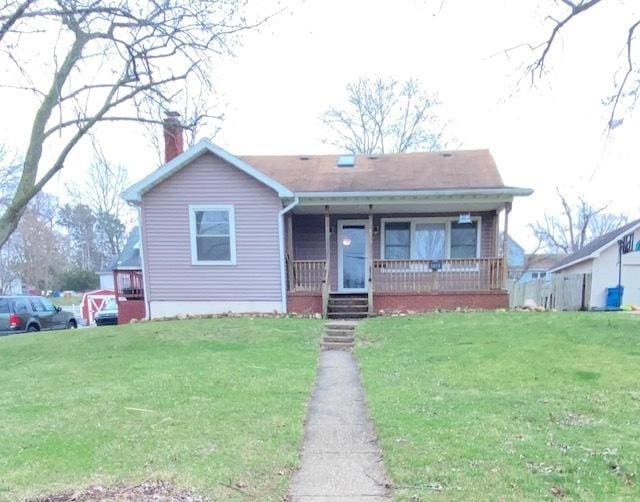 328 Castle St, Lowell, IN 46356 - bungalow-style home with a chimney, a porch, and a front yard