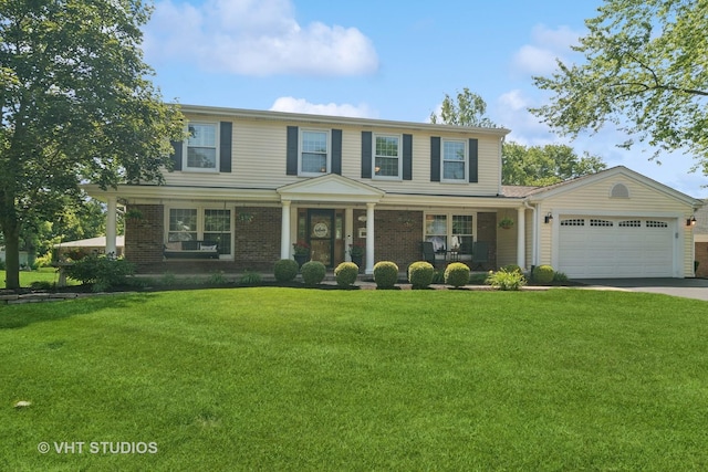 1101 S Nightingale Dr, Palatine, IL 60067 - view of front of house with covered porch, a garage, concrete driveway, and a front lawn