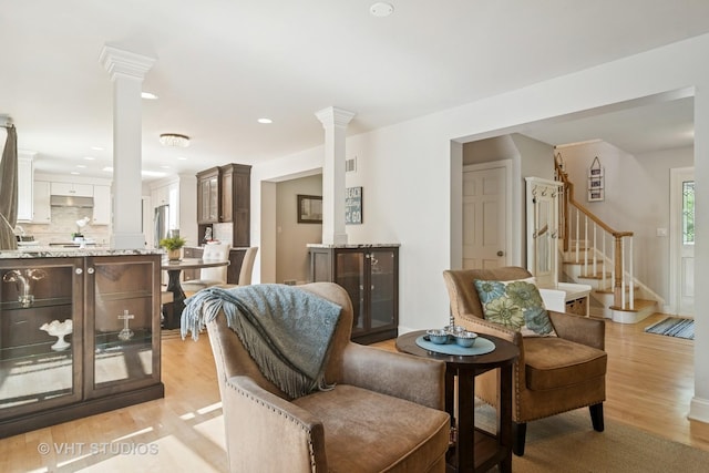 1101 S Nightingale Dr, Palatine, IL 60067 - living area with decorative columns, light wood finished floors, stairway, and recessed lighting