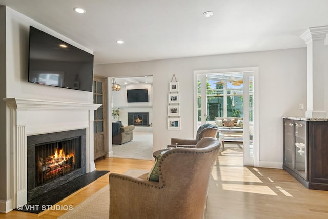 1101 S Nightingale Dr, Palatine, IL 60067 - living room featuring a lit fireplace, light wood-type flooring, recessed lighting, and a ceiling fan