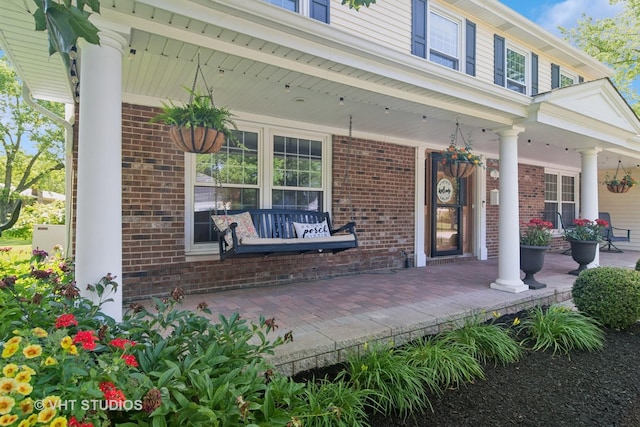 1101 S Nightingale Dr, Palatine, IL 60067 - view of exterior entry featuring a porch and brick siding