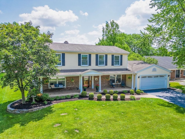 1101 S Nightingale Dr, Palatine, IL 60067 - view of front of house with driveway, a porch, an attached garage, a front yard, and brick siding