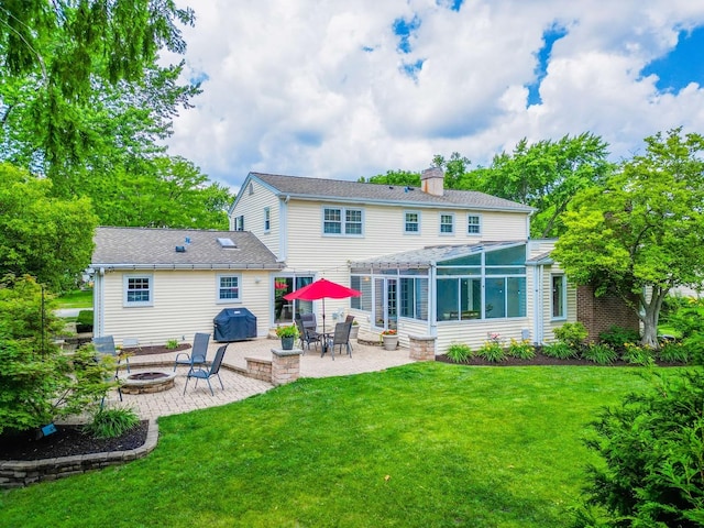 1101 S Nightingale Dr, Palatine, IL 60067 - back of property with a fire pit, a chimney, a patio area, a lawn, and a sunroom
