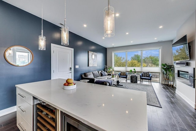 3224 N Elston Ave Unit 2S, Chicago, IL 60618 - kitchen featuring wine cooler, dark wood finished floors, baseboards, open floor plan, and decorative light fixtures