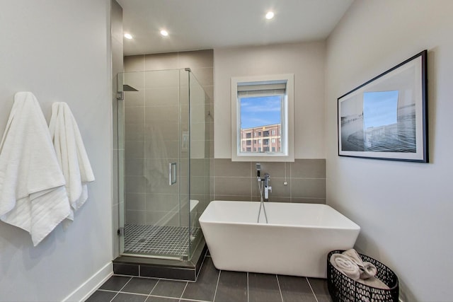 3224 N Elston Ave Unit 2S, Chicago, IL 60618 - bathroom featuring a soaking tub, tile patterned floors, a stall shower, a sink, and tile walls