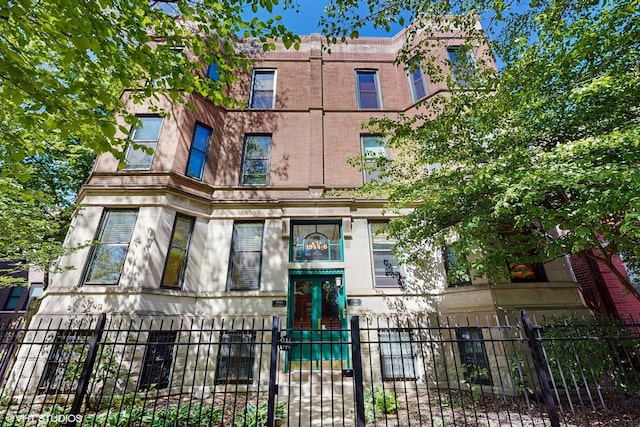 view of building exterior with a fenced front yard