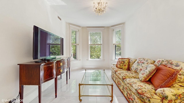 tiled living room featuring a chandelier