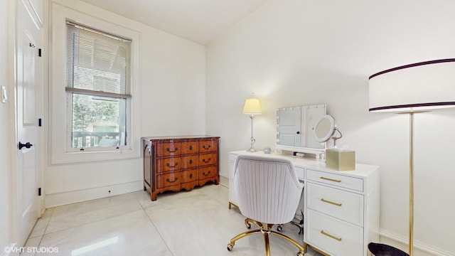 office with baseboards and light tile patterned floors
