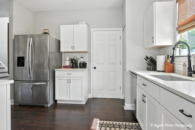 28912 Sawmill Ln, Lakemoor, IL 60051 - kitchen with appliances with stainless steel finishes, white cabinets, dark wood-style floors, tasteful backsplash, and light stone counters