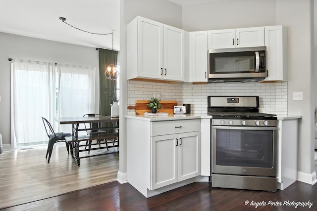 28912 Sawmill Ln, Lakemoor, IL 60051 - kitchen with stainless steel appliances, light countertops, white cabinets, backsplash, and dark wood-style floors