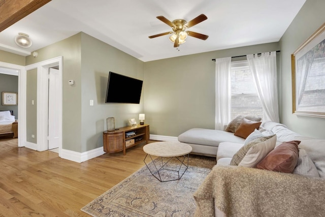 5912 W Grace St, Chicago, IL 60634 - living area with wood finished floors, ceiling fan, and baseboards