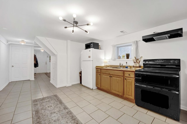 5912 W Grace St, Chicago, IL 60634 - kitchen with double oven range, freestanding refrigerator, extractor fan, a sink, and light tile patterned floors