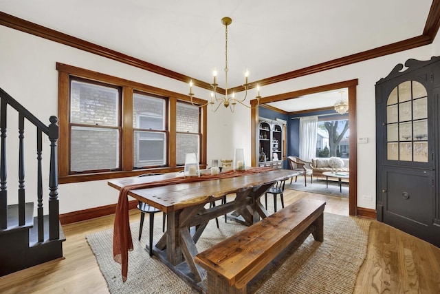5912 W Grace St, Chicago, IL 60634 - dining room featuring a chandelier, crown molding, light wood-style floors, baseboards, and stairway