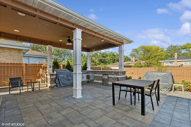 9351 Kostner Ave, Skokie, IL 60076 - fenced backyard featuring a patio area, a ceiling fan, an outdoor kitchen, and outdoor dining space