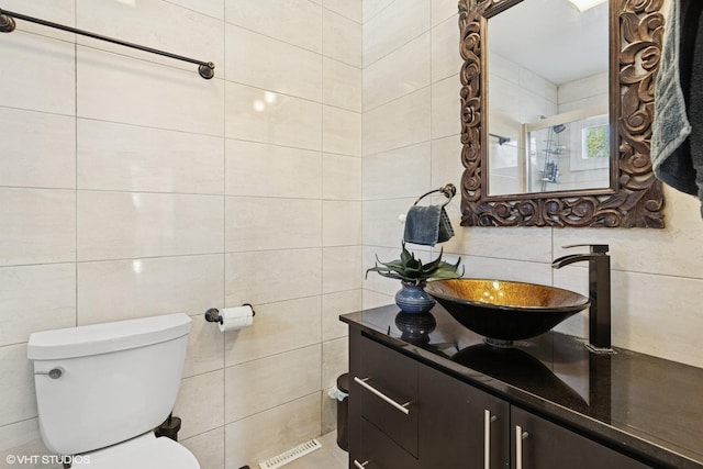 9351 Kostner Ave, Skokie, IL 60076 - bathroom with tile walls, vanity, and toilet