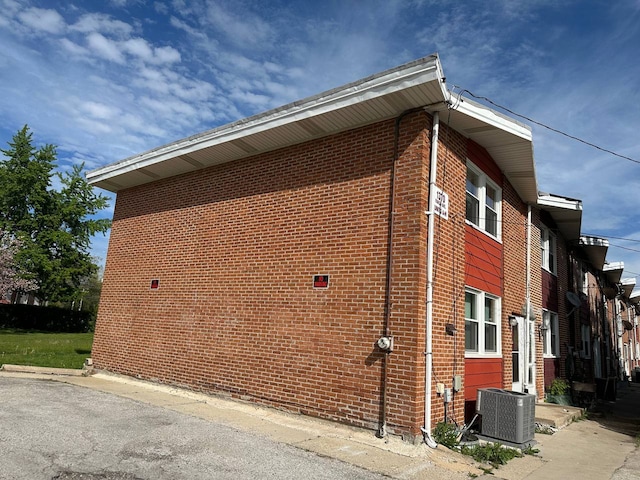 1370 Fargo Ave Unit E, Des Plaines, IL 60018 - view of property exterior with central AC unit and brick siding