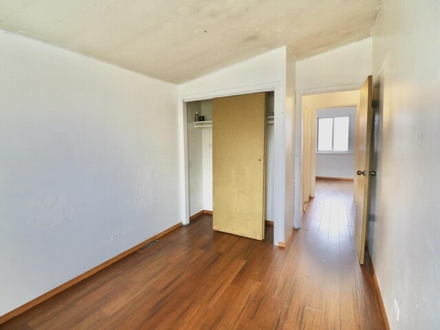 1370 Fargo Ave Unit E, Des Plaines, IL 60018 - unfurnished bedroom featuring dark wood-style flooring, a closet, and baseboards